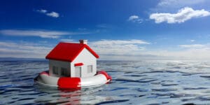 Life buoy and a small house on blue sea and sky background. 3d illustration