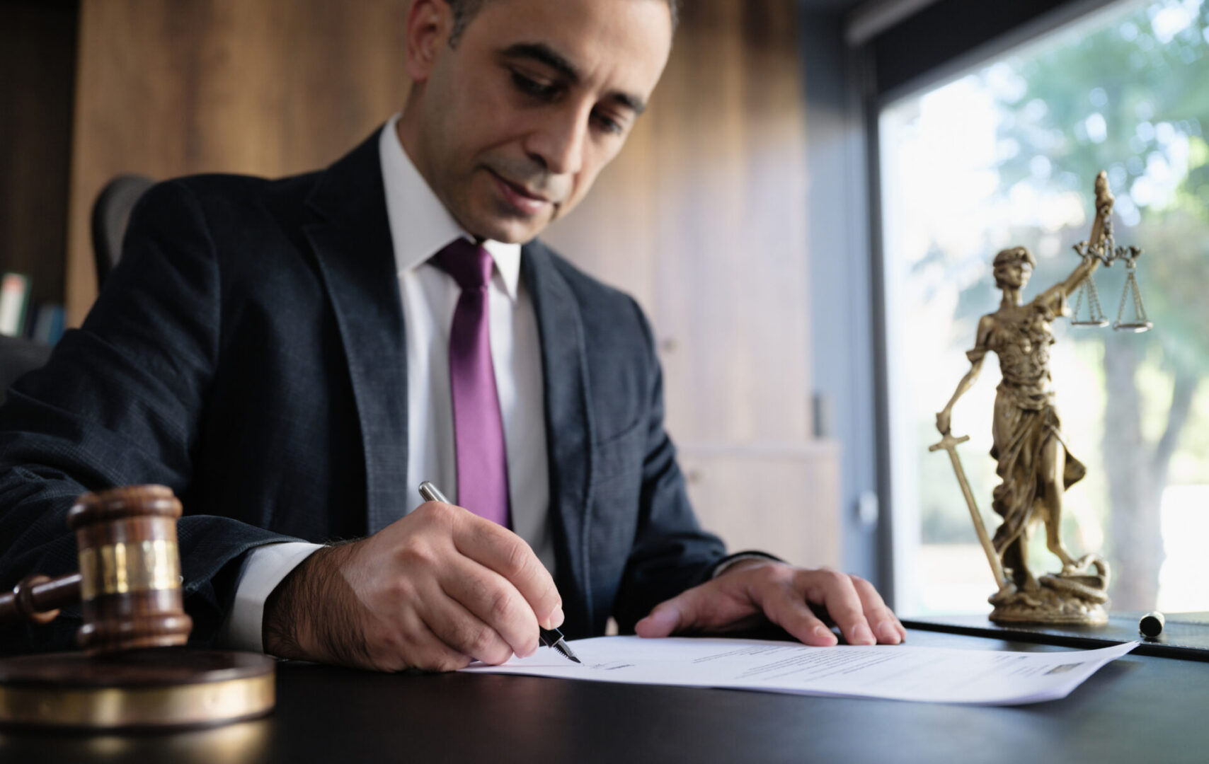 Judge or Legal advisor lawyer examining and signing legal documents.