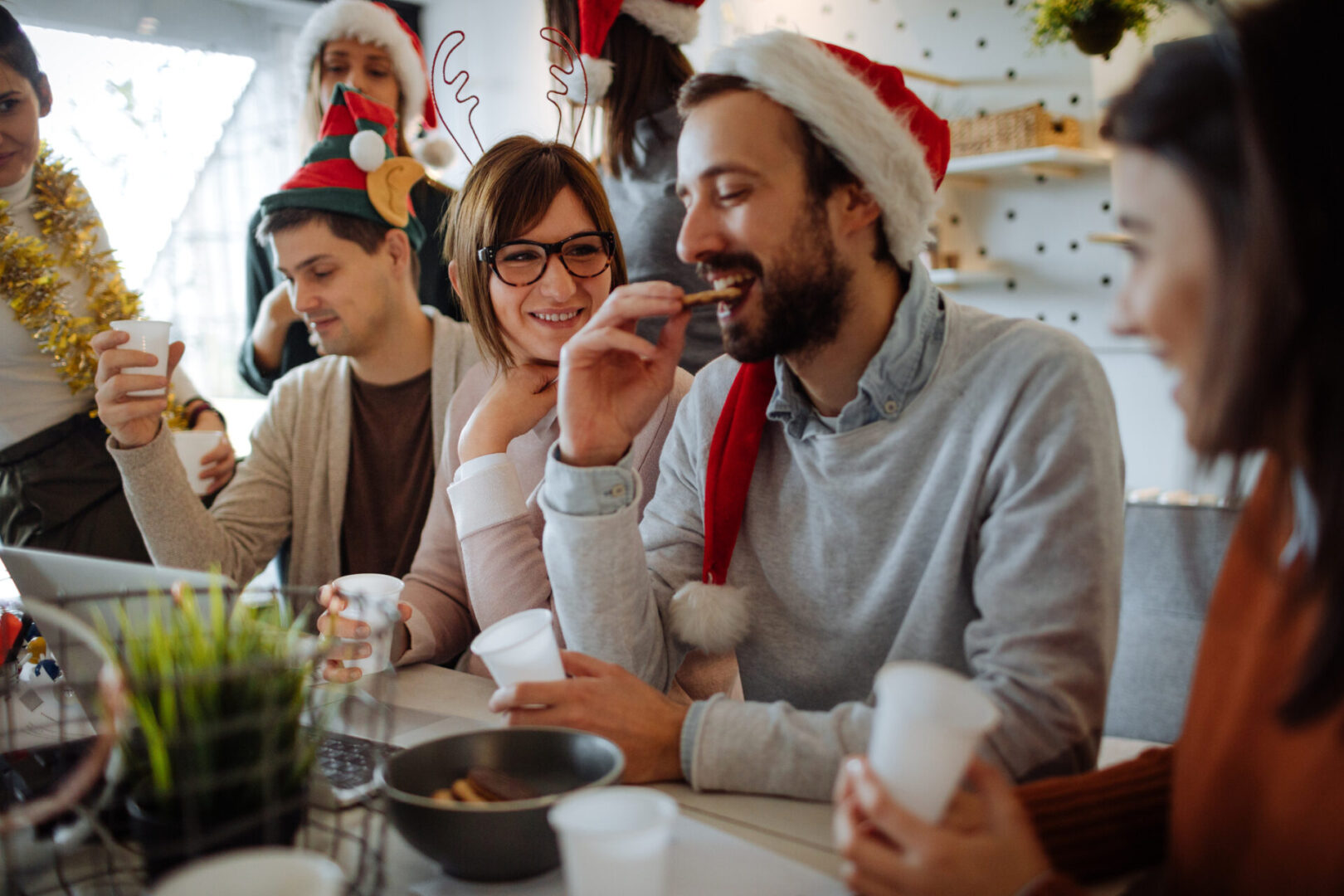 Photo of a group of coworkers celebrating Christmas together in their office