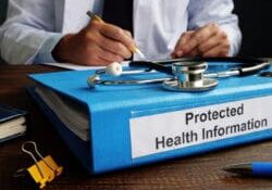 Blue Folder with protected health information PHI as part of HIPAA rules.