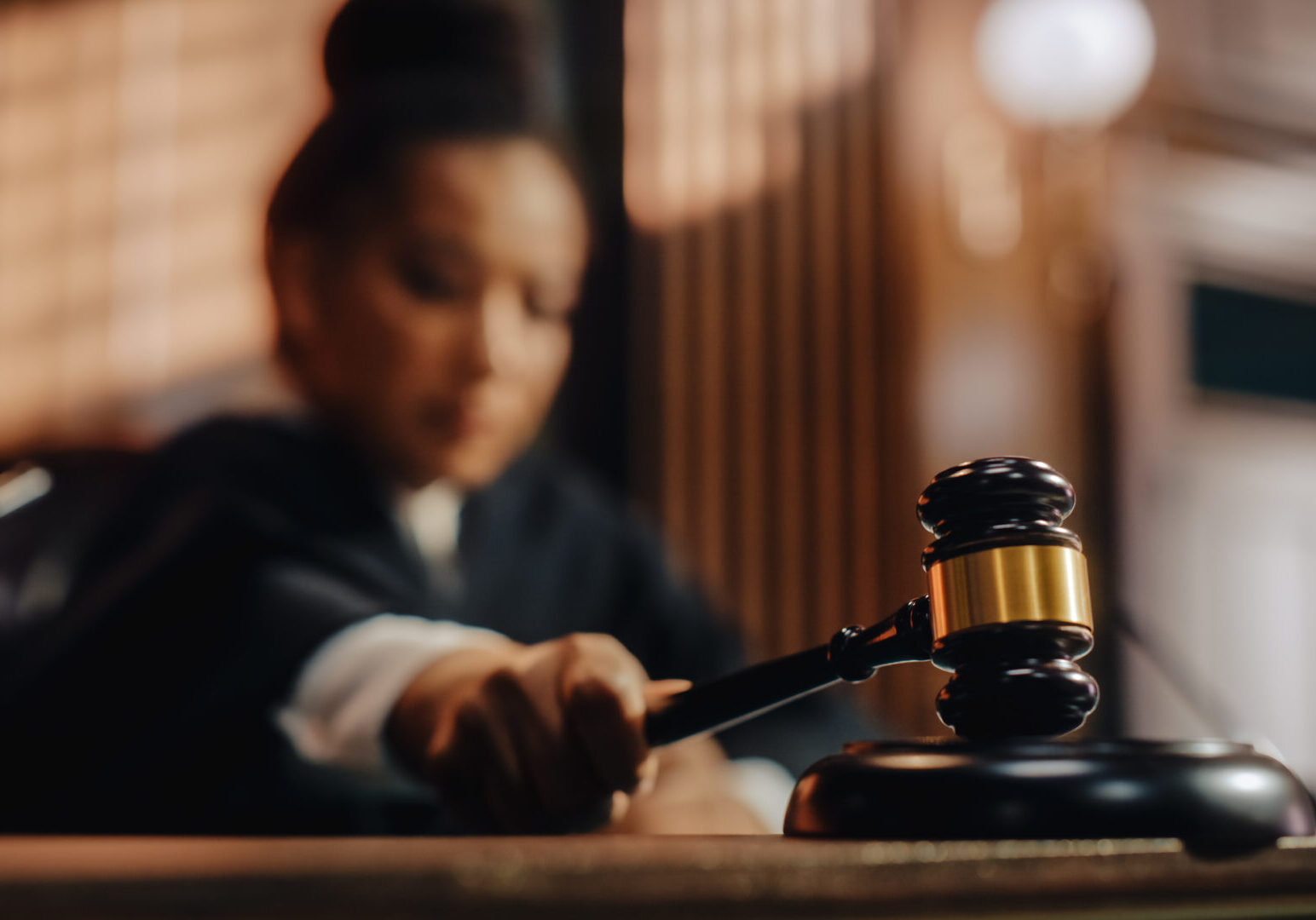 Court of Law Trial in Session: Honorable Female Judge Pronouncing Sentence, striking Gavel. Focus on Mallet, Hammer. Cinematic Shot of Dramatic Not Guilty Verdict. Close-up Shot.