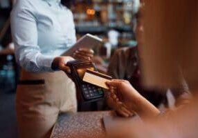 Close up of customer paying with credit card in a restaurant.