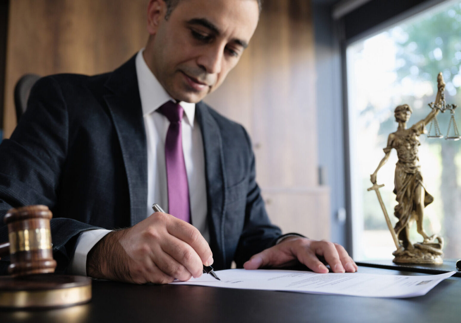 Judge or Legal advisor lawyer examining and signing legal documents.