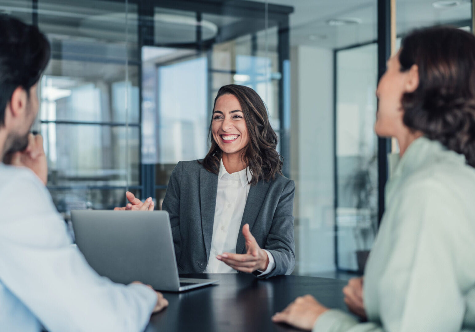 Shot of group of business persons in business meeting. Three entrepreneurs on meeting in board room. Corporate business team on meeting in modern office. Female manager discussing new project with her colleagues. Company owner on a meeting with two of her employees in her office.