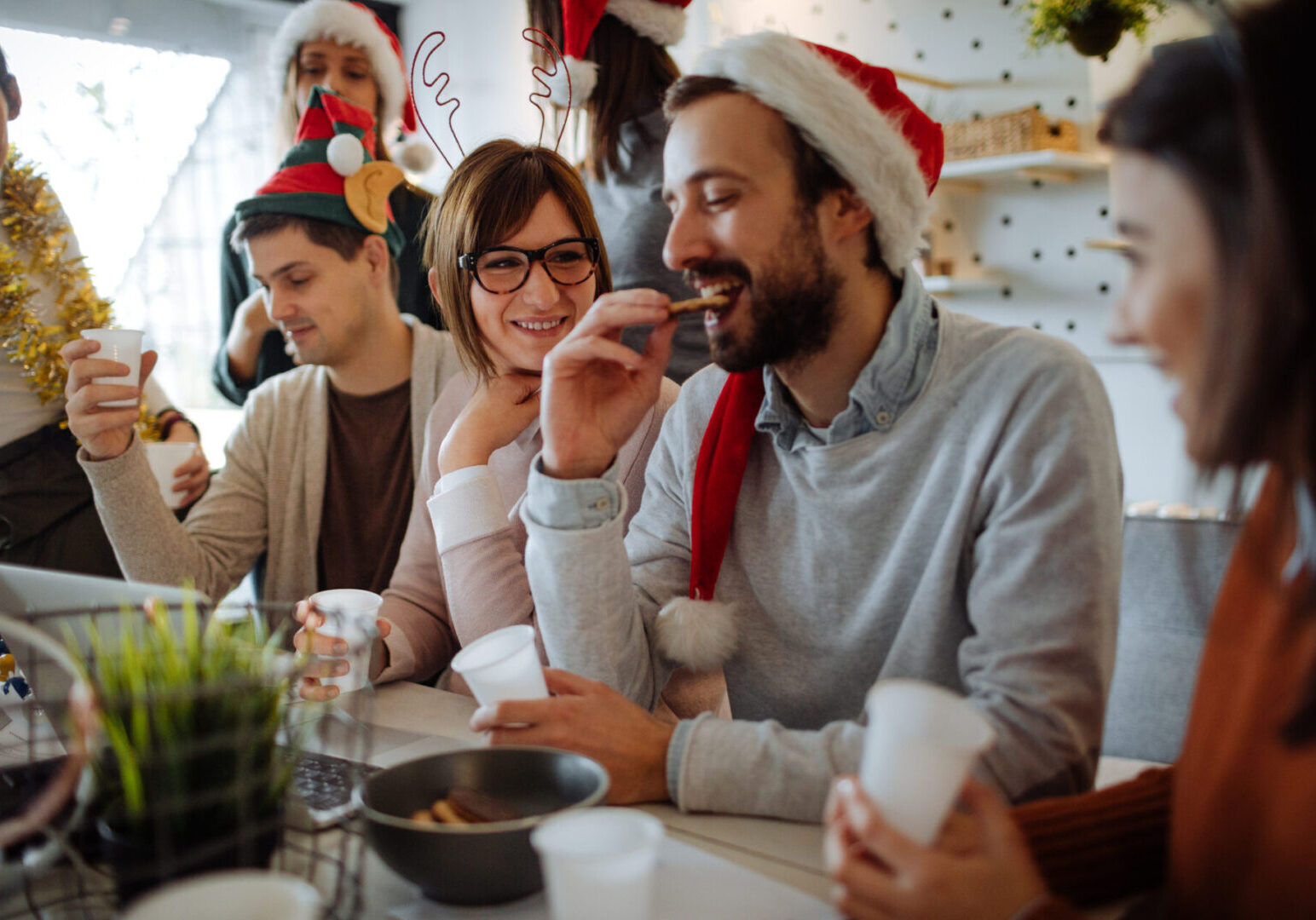 Photo of a group of coworkers celebrating Christmas together in their office